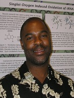 Man standing in front of RNA research poster smiling